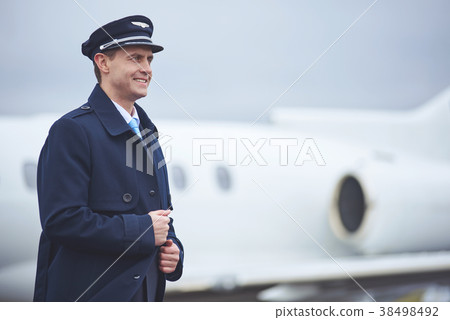Cheerful pilot situating on street Cheerful pilot situating on street 38498492
