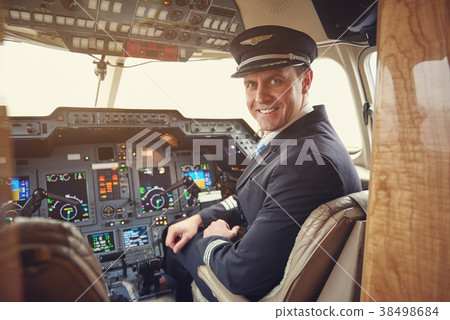 Happy pilot locating in cabin 38498684