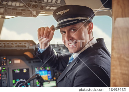 Cheerful aviator sitting in cockpit 38498685