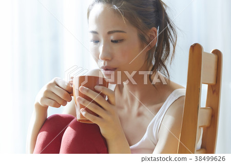 A woman drinking a drink A woman drinking a drink 38499626