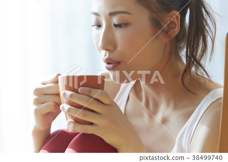 A woman drinking a drink A woman drinking a drink 38499740