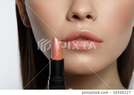 Voluptuous young woman doing makeup Voluptuous young woman doing makeup 38500227