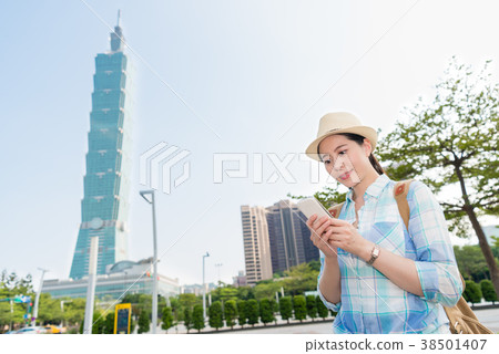 The girl checking her cellphone in Taipei 101. The girl checking her cellphone in Taipei 101. 38501407