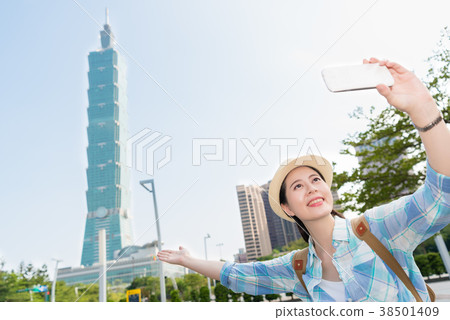 Modern girl introducing Taipei 101. 38501409