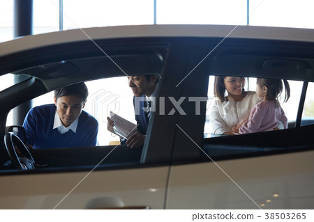 Family considering car dealership purchase Family considering car dealership purchase 38503265