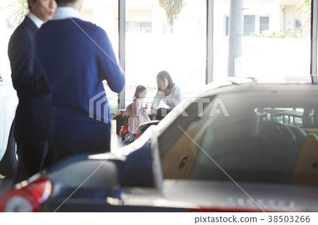Family considering car dealership purchase 38503266