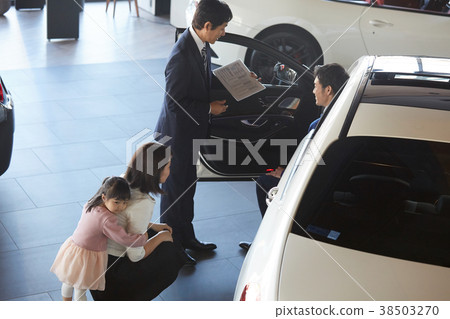Family considering car dealership purchase 38503270