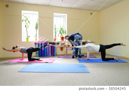 Three young women in yoga classes Three young women in yoga classes 38504245