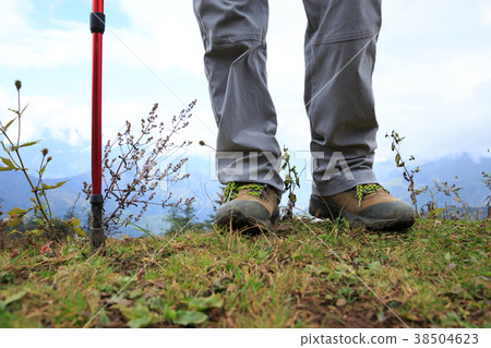 woman hiker legs standing on mountain top woman hiker legs standing on mountain top 38504623