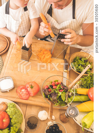 Father is cooking with his son 38505680