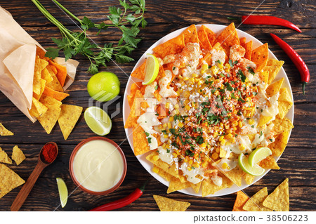 nachos topped a melted creamy cheese sauce nachos topped a melted creamy cheese sauce 38506223
