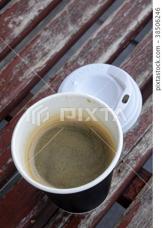 Hot Americano coffee in take away cup on table Hot Americano coffee in take away cup on table 38506246