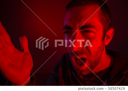 Man with angry facial expression screaming loud Man with angry facial expression screaming loud 38507429