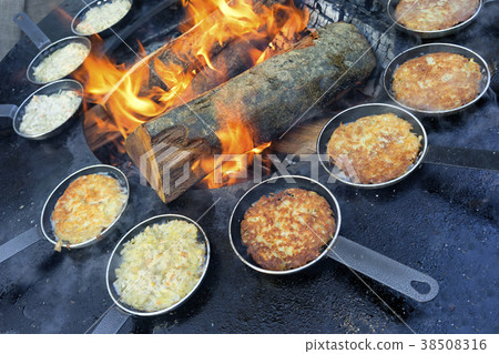 Pellets in a frying pan by the fire Pellets in a frying pan by the fire 38508316