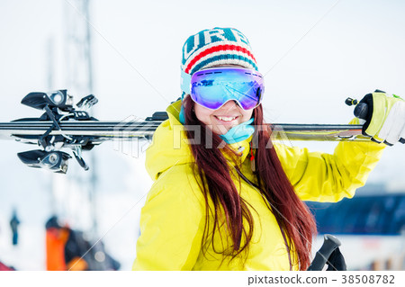 Portrait of smiling sports woman with skis on her 38508782