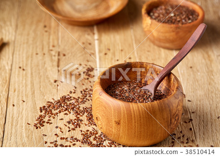 Flax seeds in wooden bowl and spoon on rustic 38510414