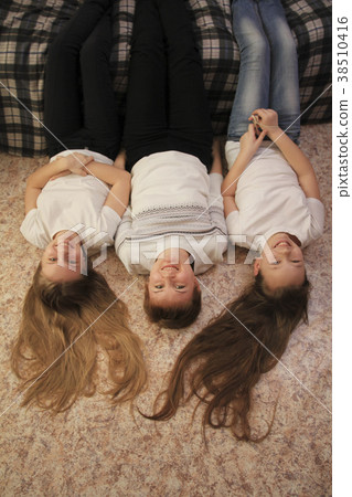 Portrait of young mom and her two teen daughters 38510416