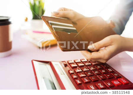 woman is holding purse, credit card in hands and woman is holding purse, credit card in hands and 38511548