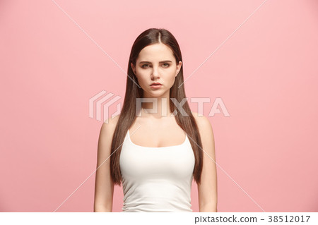 The serious business woman standing and looking at 38512017