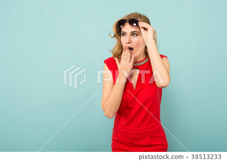 Shocked woman in red overalls and sunglasses 38513233