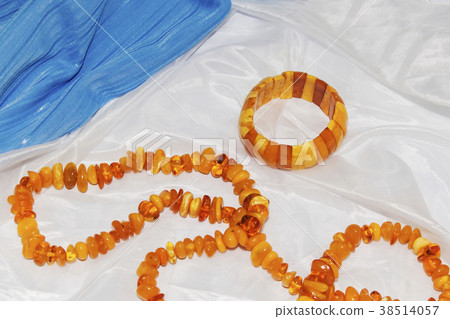 Amber necklace on a light blue background 38514057