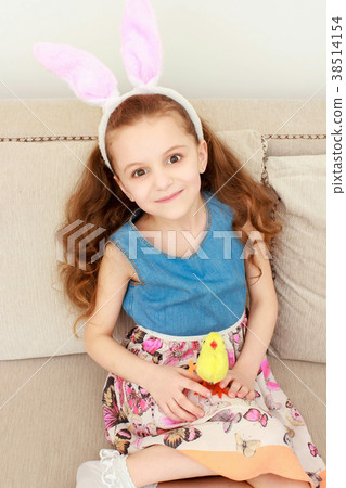 Cute little child wearing bunny ears on Easter day Cute little child wearing bunny ears on Easter day 38514154