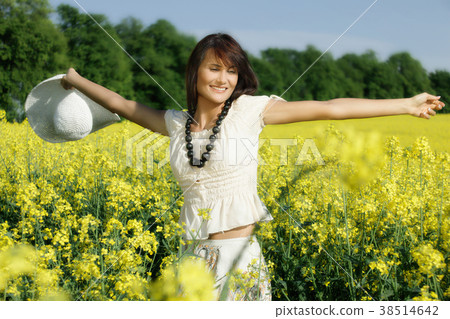 Young woman in the rape field Young woman in the rape field 38514642