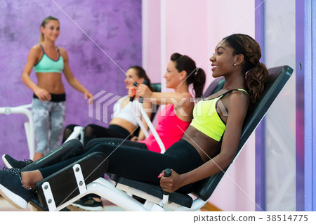 Young woman doing exercise for legs while 38514775
