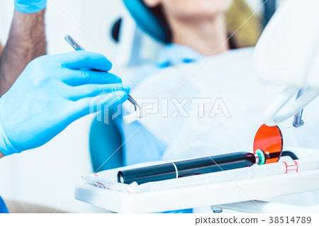 Close-up of the hand of a dentist preparing a Close-up of the hand of a dentist preparing a 38514789