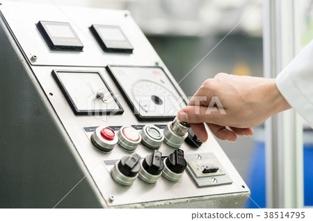 Close-up of hand of woman turning on an industrial 38514795