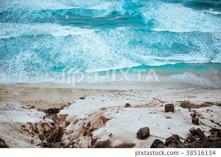 Quaint view of azure roaring ocean, black volcanic 38516134