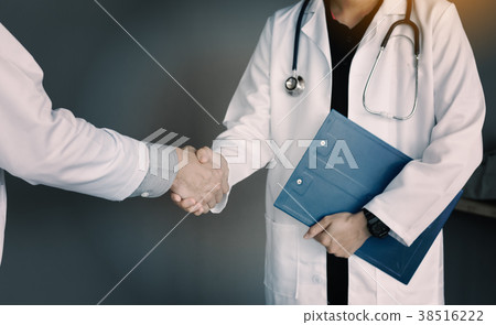 Shaking hands with a female doctor. 38516222