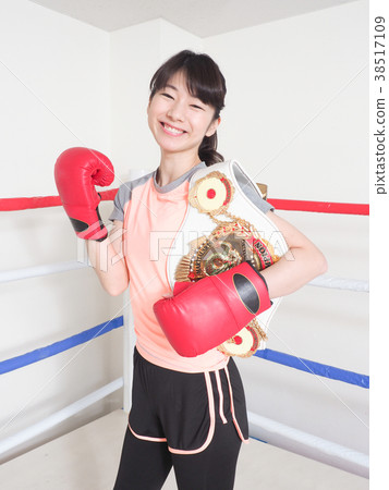 Smiling woman holding a champion belt (Cooperating Shiitaru Sekine) 38517109