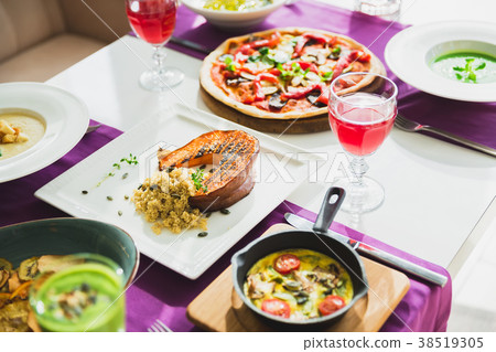 Table with vegetarian dishes - pizza, salads, soup Table with vegetarian dishes - pizza, salads, soup 38519305