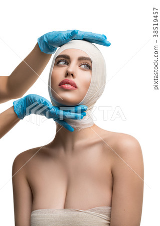 Beautiful woman examined by plastic surgeon Beautiful woman examined by plastic surgeon 38519457