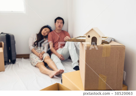 Tired couple sleep in new house 38520063