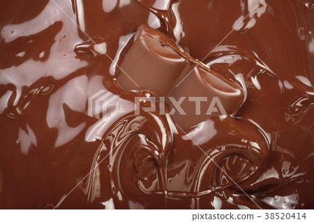 Melted chocolate and pieces of chocolate bar as a Melted chocolate and pieces of chocolate bar as a 38520414
