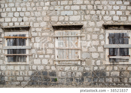 boarded-up Windows in an old stone building boarded-up Windows in an old stone building 38521837