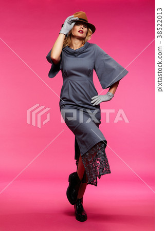 Beautiful blonde in a hat. Pink background. 38522013