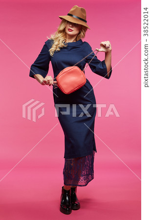Beautiful blonde in a hat. Pink background. Beautiful blonde in a hat. Pink background. 38522014