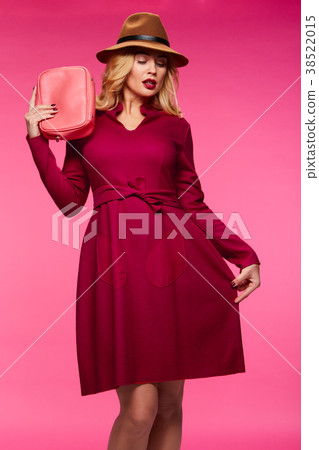 Beautiful blonde in a hat. Pink background. Beautiful blonde in a hat. Pink background. 38522015