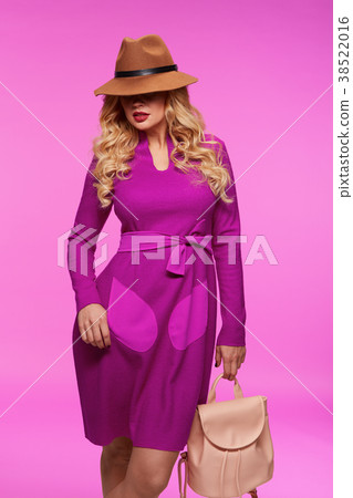 Beautiful blonde in a hat. Pink background. Beautiful blonde in a hat. Pink background. 38522016