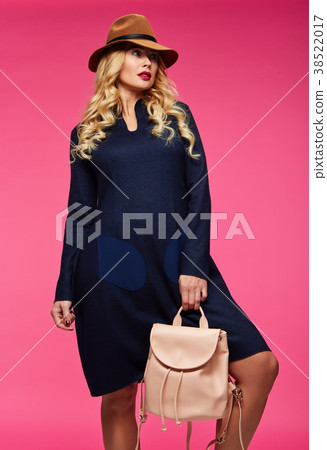 Beautiful blonde in a hat. Pink background. 38522017