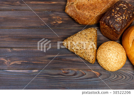 assortment of baked bread on wood table 38522206