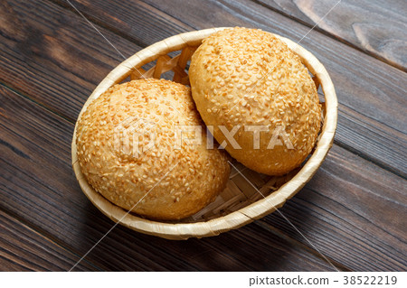 Homemade fresh buns in a basket on old table Homemade fresh buns in a basket on old table 38522219