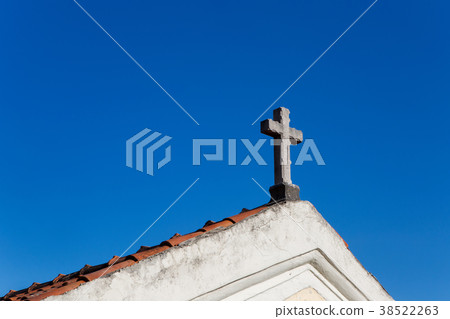 cross on the roof of the Church with orange tiles cross on the roof of the Church with orange tiles 38522263