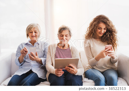 A teenage girl, mother and grandmother with tablet 38522313