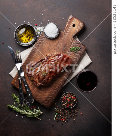 Grilled ribeye beef steak with red wine, herbs  38523145