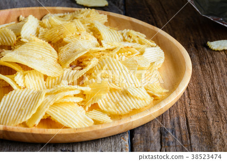 Snacks in a wooden dish on a table Snacks in a wooden dish on a table 38523474