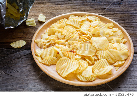 Snacks in a wooden dish on a table Snacks in a wooden dish on a table 38523476